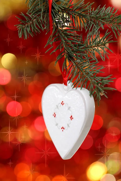 Christmas white heart with against blurred background — Stock Photo, Image