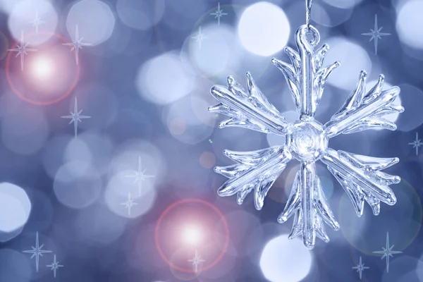 Glass snowflake against blurred background — Stock Photo, Image