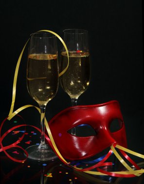 Champagne in two glasses with streamers and carnival mask clipart