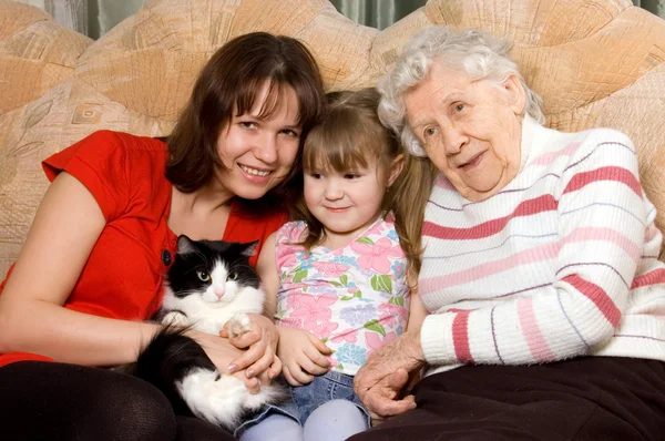 Rodina na pohovce s kočkou — Stock fotografie