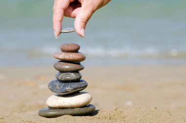 Heap of stones against the sea clipart