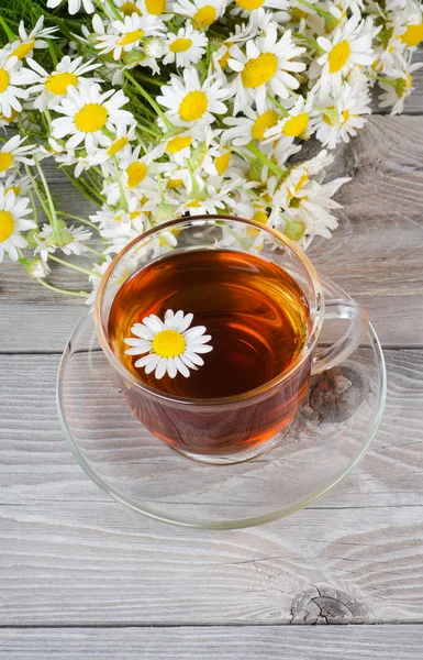 Glass cup with a camomile tea — Stock Photo, Image