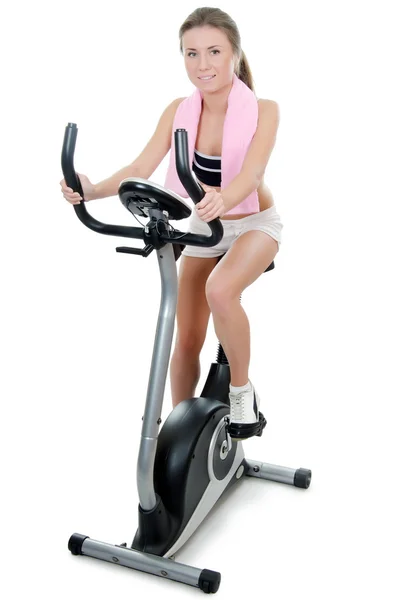 The girl is engaged on a velosimulator — Stock Photo, Image