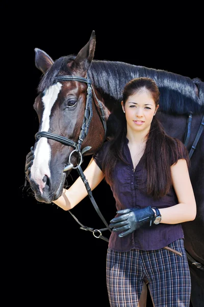 Menina jovem com cavalo esporte preto — Fotografia de Stock