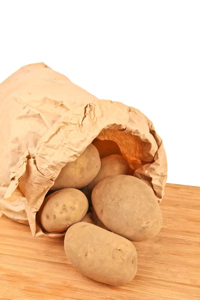 Fresh potatoes in a brown paper bag — Stock Photo, Image