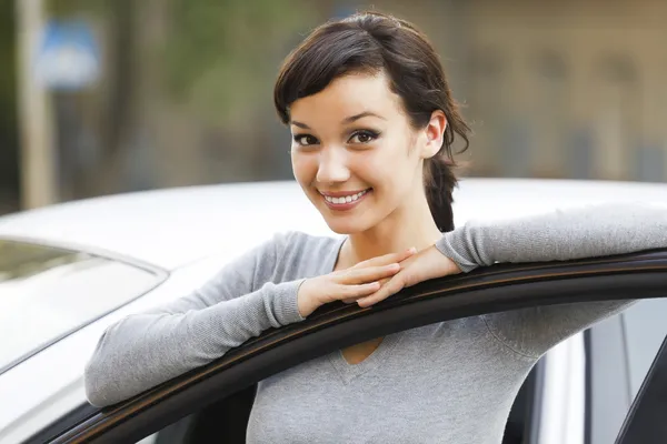 Pretty girl and white car — Stock Photo, Image