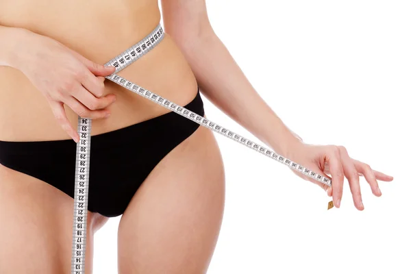 Woman measures her waist belly — Stock Photo, Image