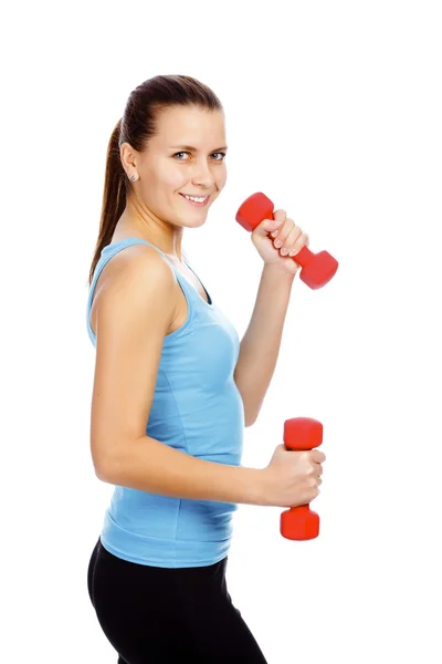 Smiling girl lifting barbells on a white background — Stock Photo, Image