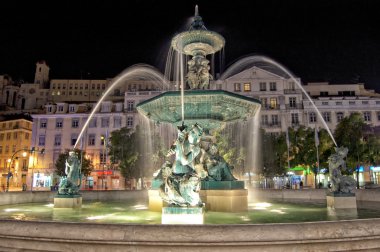 Night view of the fountain at Rossio square, Lisbon, Portugal clipart