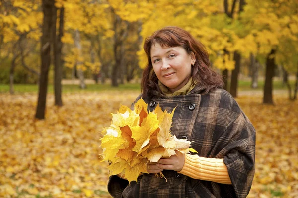 stock image Portrait of woman in autumn leaves