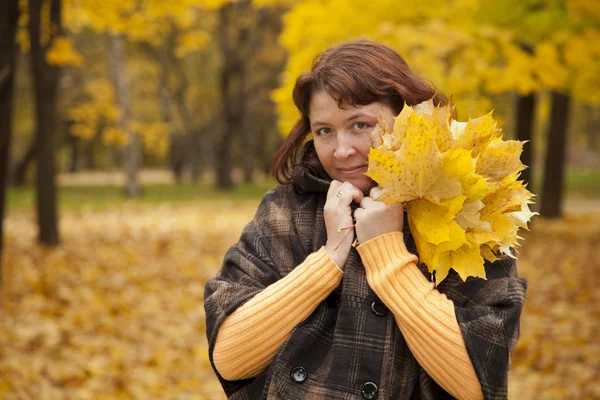 stock image Portrait of woman in autumn leaves