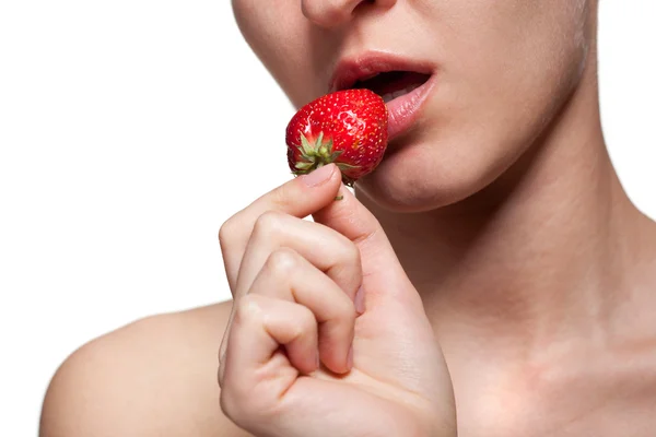 Young woman biting strawberry isolated on white — Stock Photo, Image