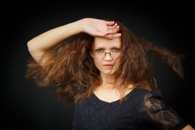 Girl with long hair on a black background