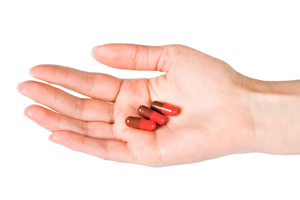 Capsules in woman's hand — Stock Photo, Image