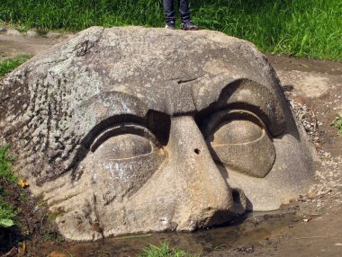Stone head in park clipart