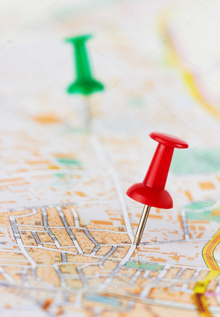 Red and green pushpin on a map