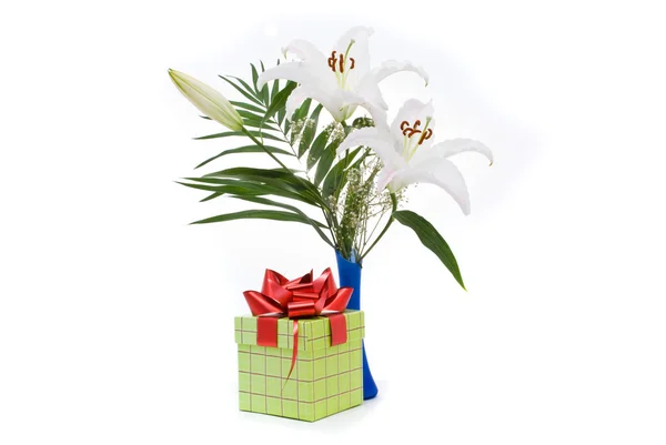 Beautiful bouquet of white lilies and present box on a white bac — Stock Photo, Image