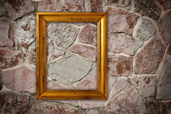 Gold frame on a old wall background — Stock Photo, Image