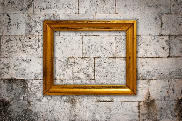Gold frame on a old wall background — Stock Photo, Image