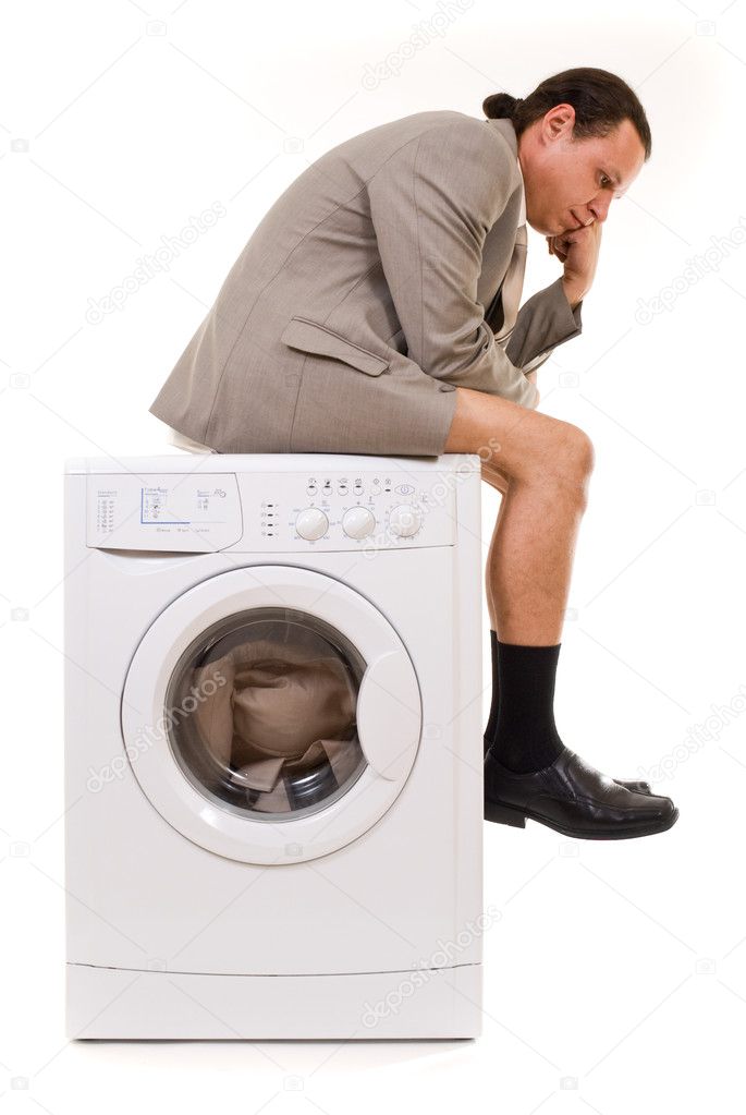 Man wipes trousers in the washing machine