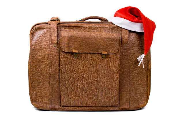 Old suitcase with a Christmas hat isolated on a white background — Stock Photo, Image