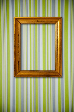 Gold frame on striped vintage wallpaper background clipart