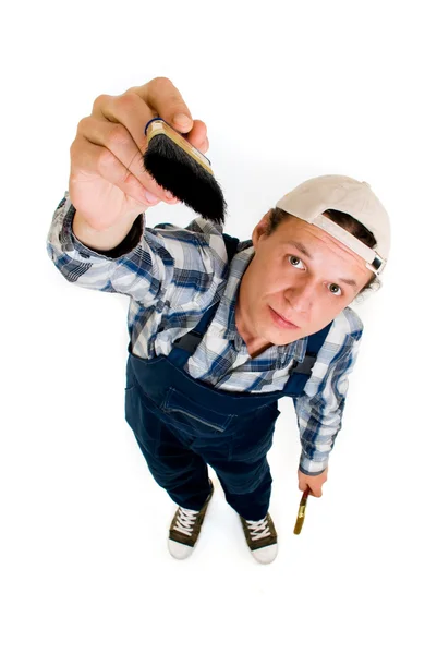 Worker with brush in hands on white background — Stock Photo, Image