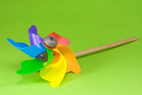 stock image Colorful pinwheel over green