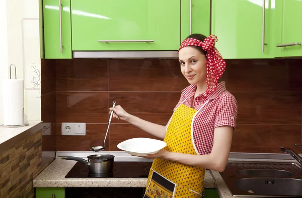 Beautiful happy woman in kitchen interior cooking — Stock Photo, Image