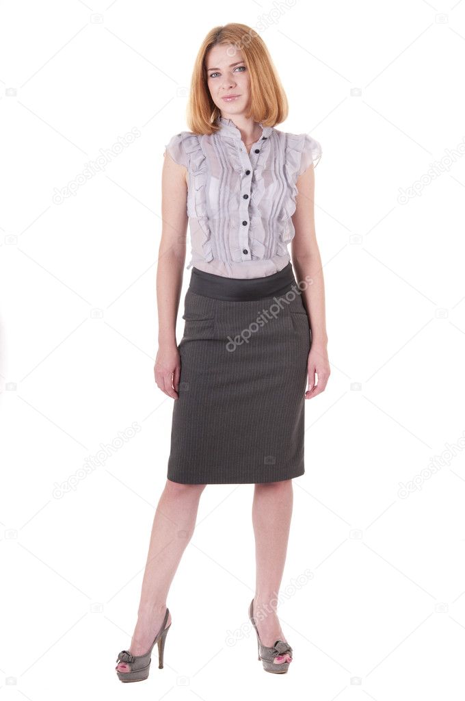 Beautiful young woman in blouse and skirt on white