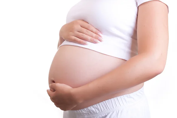 stock image Pregnant woman touching her belly with hands
