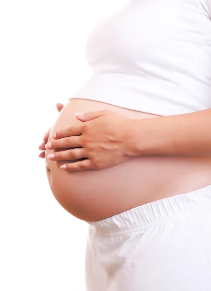 stock image Pregnant woman touching her belly with hands