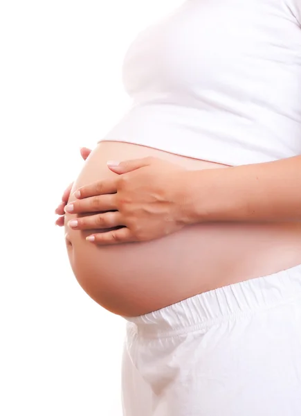 Беременная женщина прикасается руками к животу Лицензионные Стоковые Изображения