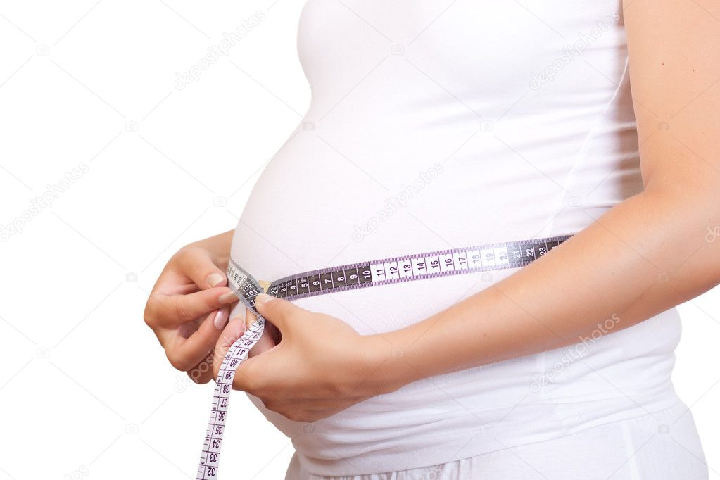 Pregnant woman touching her belly with hands