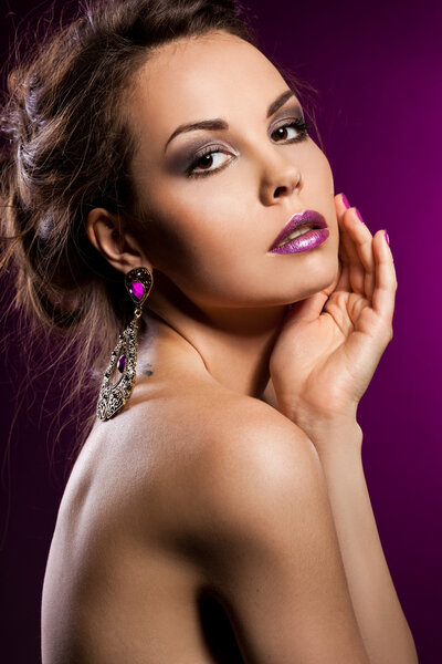 Elegant fashionable woman with violet jewelry