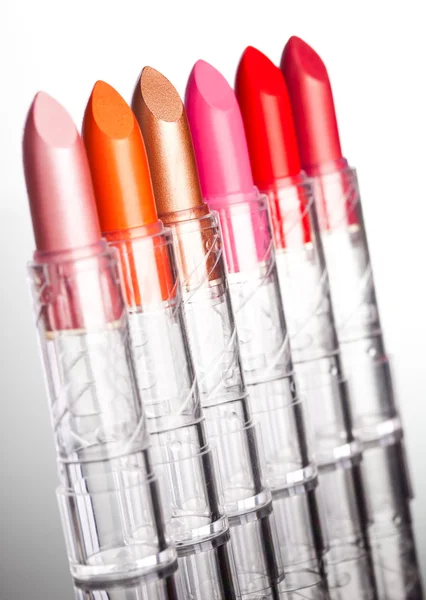 Many lipsticks on white background (shallow DOF) — Stock Photo, Image