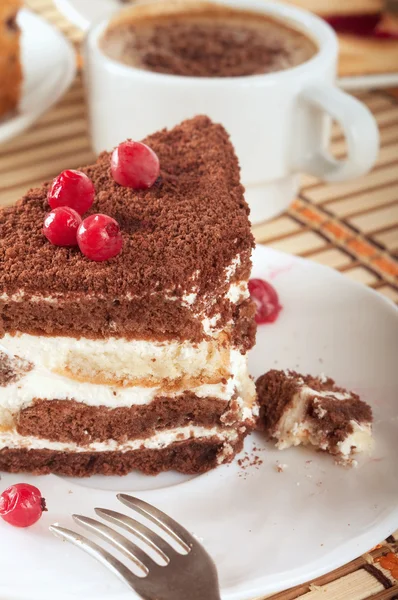 Close-up of white cup of coffee and chocolate cake — Stock Photo, Image