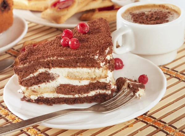 Close-up of white cup of coffee and chocolate cake — Stock Photo, Image