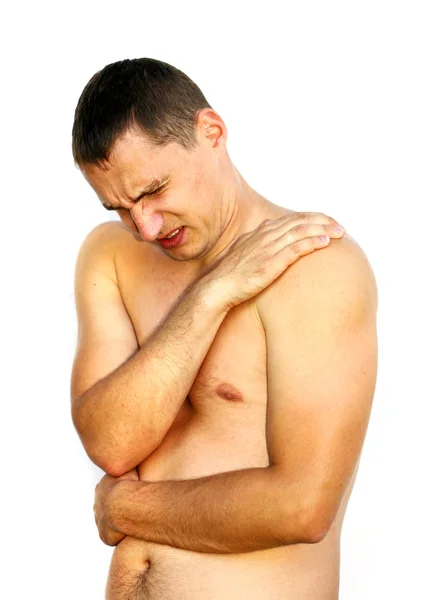 Молодой человек испытывает боль в плече — стоковое фото
