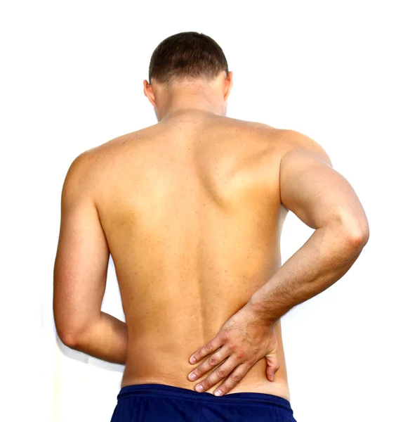 У молодого человека боли в спине — стоковое фото