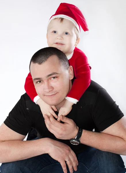 Father with his little son sitting pick-a-back in festive unifor — Stock Photo, Image