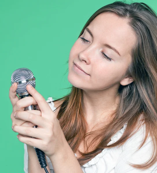 Portrait of beautiful singer girl with microphone in hand — Stock Photo, Image