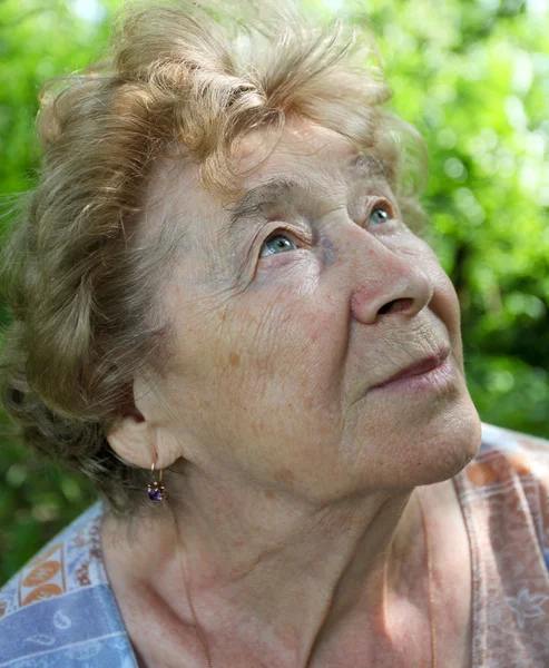 stock image Portrait of a dreaming senior woman outdoor