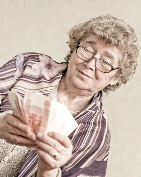 Elderly happy woman with pack of money — Stock Photo, Image
