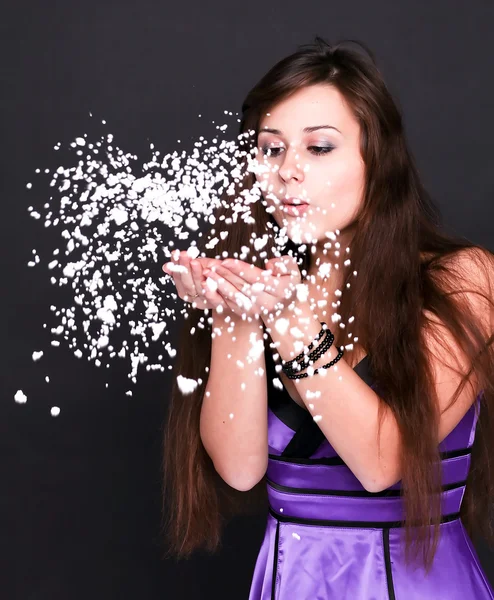 Portrait of funny lovely teenage girl inflating snowflakes, stud — Stock Photo, Image