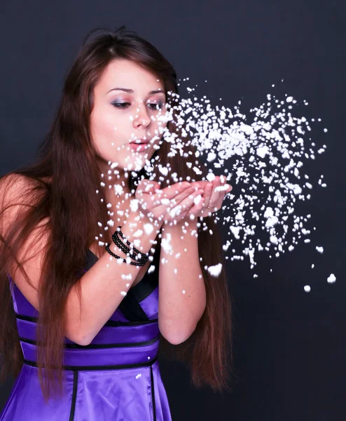 Portrait of funny lovely teenage girl inflating snowflakes, stud — Stock Photo, Image
