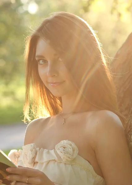 Porträt eines attraktiven jungen Mädchens, das Buch in schönen Sonnen liest — Stockfoto