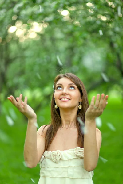 Прыжки красивая девушка с открытыми руками в весеннем сельском парке — стоковое фото