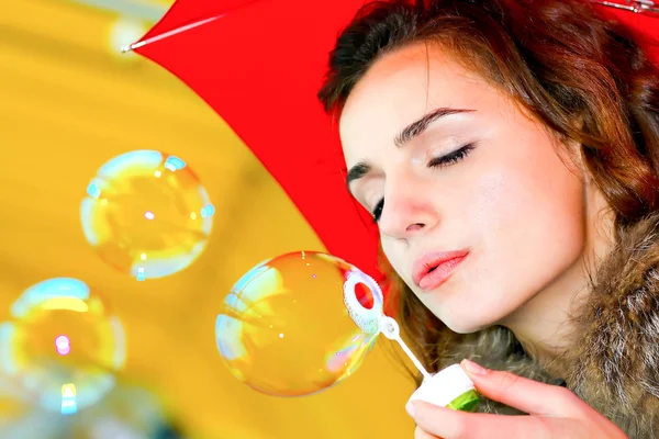 Smile teen inflating soap bubbles — Stock Photo, Image