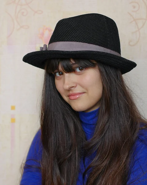 Portrait of beautiful brunette girl with black hat — Stock Photo, Image